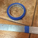 Use tape to overlap the straps and secure them to each other. Use enough straps to fit behind the quilt back. 